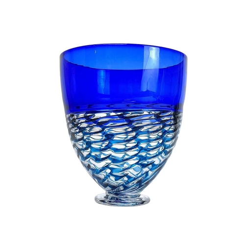 320 - Bob Crooks (1965). A footed glass vase. with a broad blue border and trailed blue trellis design bel... 