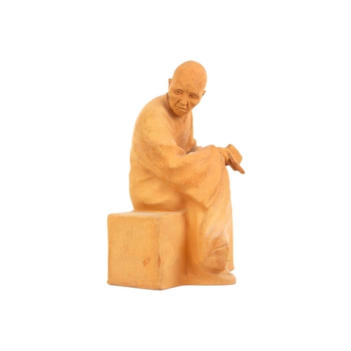 343 - Gaston Hauchecorne (1880 - 1945) A terracotta figure of a Chinese dignitary. Probably a monk, seated... 