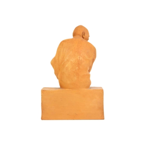 343 - Gaston Hauchecorne (1880 - 1945) A terracotta figure of a Chinese dignitary. Probably a monk, seated... 