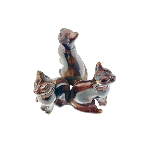 35 - An Egyptian bronze group of three cats. After the antique, late 19th/early 20th century, with a lacq... 