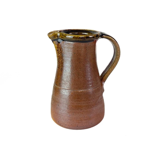 413 - A Muchelney Pottery jug. Impressed marks, height 20cm, together with a Muchelney Pottery jar and cov... 