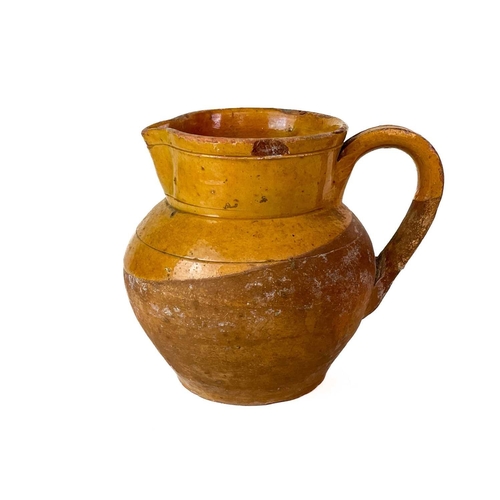 413 - A Muchelney Pottery jug. Impressed marks, height 20cm, together with a Muchelney Pottery jar and cov... 