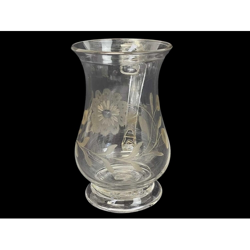 415 - A George III baluster glass small mug. With a folded rim, loop handle, and floral engraved decoratio... 