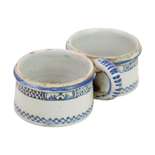 422 - A painted Delft double cruet holder. 18th century, painted in blue with a diaper and cross pattern, ... 