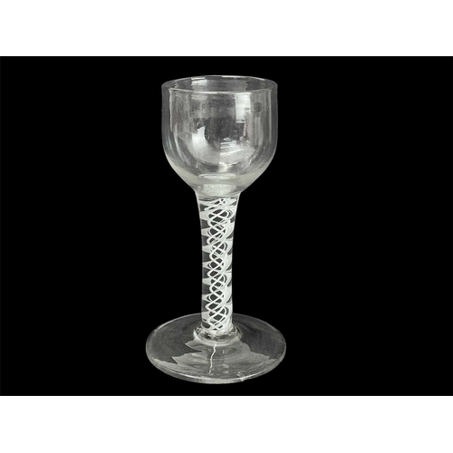 427 - An 18th century English wine glass. With ogee bowl on an opaque spiral twist stem, height 13cm.