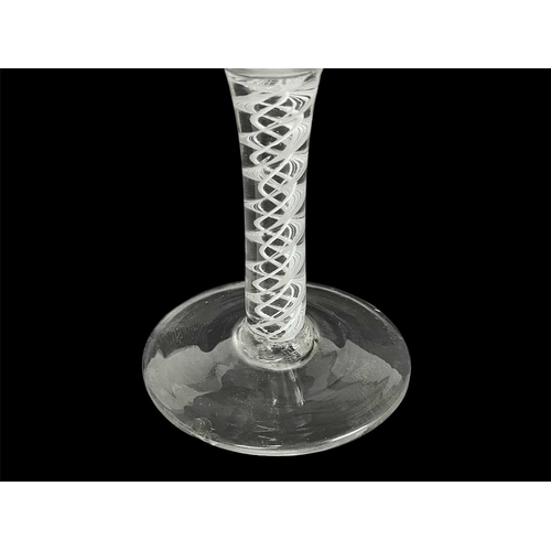 427 - An 18th century English wine glass. With ogee bowl on an opaque spiral twist stem, height 13cm.