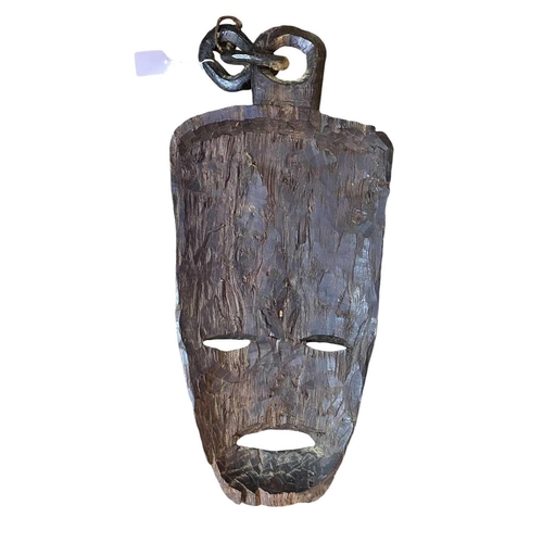 44 - A large African carved mask. Inlaid with bone, height 93cm together with another African carved mask... 