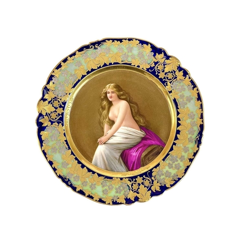 480 - A 'Vienna' porcelain plate titled Solitude. Circa 1900, painted with the seated nude figure, within ... 