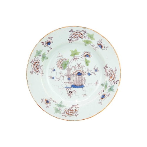 485 - An unusual 18th century English Delft plate. Probably Liverpool in Fazackerley type colours, with a ... 