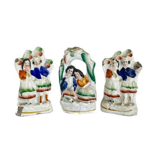 486 - A Victorian Staffordshire pottery flat back figure group of a harvest couple. Height 34cm together w... 