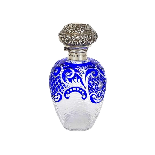 487 - A Victorian silver mounted blue overlay glass scent bottle. Probably Stourbridge, with a repousse de... 