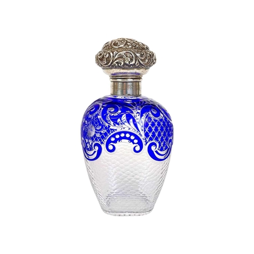 487 - A Victorian silver mounted blue overlay glass scent bottle. Probably Stourbridge, with a repousse de... 