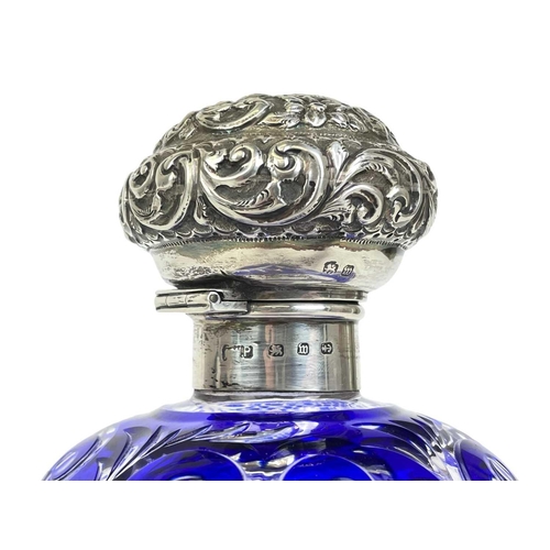 487 - A Victorian silver mounted blue overlay glass scent bottle. Probably Stourbridge, with a repousse de... 