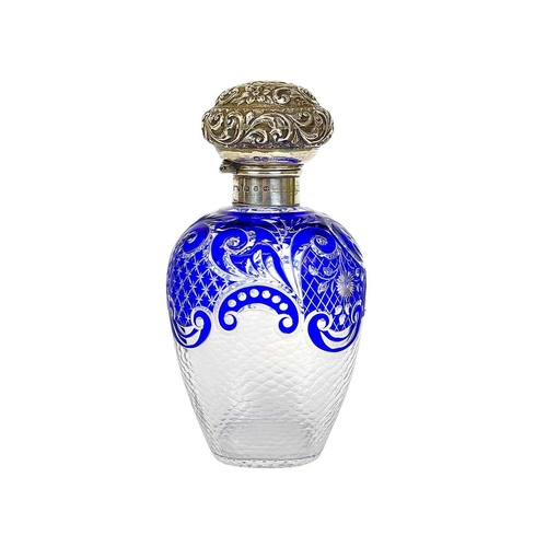 487 - A Victorian silver mounted blue overlay glass scent bottle. Probably Stourbridge, with a repousse de... 