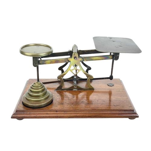 49 - A set of Victorian mahogany and brass postal scales, by Avery. With weights, width 28.5cm, together ... 