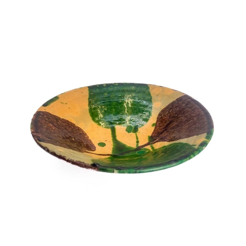 495 - An Afghan pottery dish. With green and umber glaze diameter 26cm together with a matching bowl. (2)