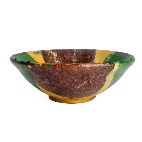 495 - An Afghan pottery dish. With green and umber glaze diameter 26cm together with a matching bowl. (2)