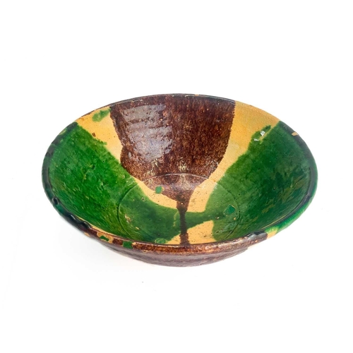 495 - An Afghan pottery dish. With green and umber glaze diameter 26cm together with a matching bowl. (2)