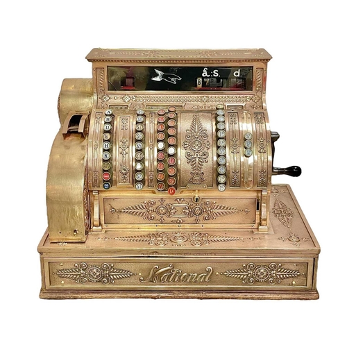 50 - A polished brass National cash register. Circa 1900, with ornate cast and pierced decoration, with c... 