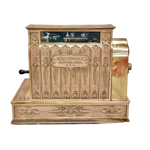 50 - A polished brass National cash register. Circa 1900, with ornate cast and pierced decoration, with c... 