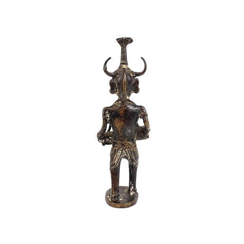 53 - An Indian cast bronze figure of a musician. Dhokra, West Bengal, the figure with a horned headpiece,... 