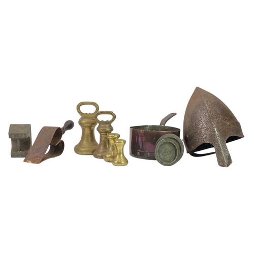 56 - A collection of seven various brass weights. Two Victorian trivets, a 1943 brass shell case, a coppe... 