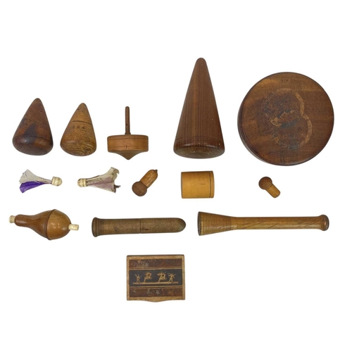 61 - A collection of treen. To include three lead turnpins, a spinning top, bone carved pick-up-sticks ga... 