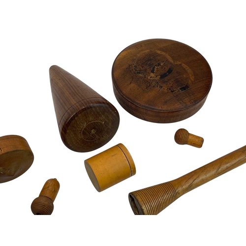 61 - A collection of treen. To include three lead turnpins, a spinning top, bone carved pick-up-sticks ga... 