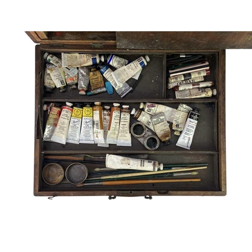 66 - A hardwood Artist's box. Mid 20th century, the hinged cover incorporating an easel, with palette and... 