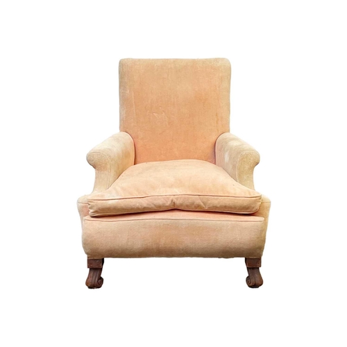 705 - A salmon pink velvet upholstered armchair. 20th century, raised on mahogany scroll front feet, heigh... 