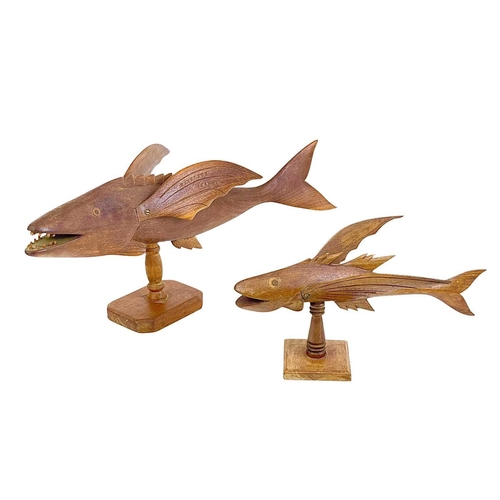 72 - A carved hardwood flying fish, stamped John Christian Pitcairn Island. Length 47cm, on a turned stan... 