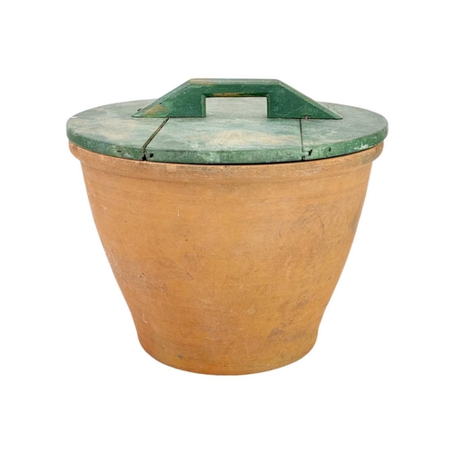 78 - A large terracotta crock pot and wood cover. The interior with umber glaze, diameter 40cm.