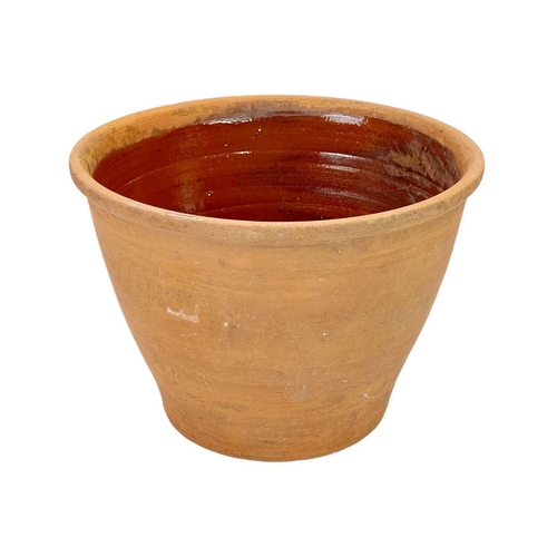 78 - A large terracotta crock pot and wood cover. The interior with umber glaze, diameter 40cm.