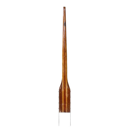 81 - A laminated ash and mahogany yacht tiller. With a stainless steel yoke, length 164cm.