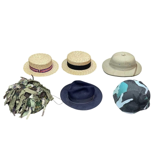 89 - A Trunk of various military and other headwear. Comprising two boaters, two pith helmets, a US balli... 