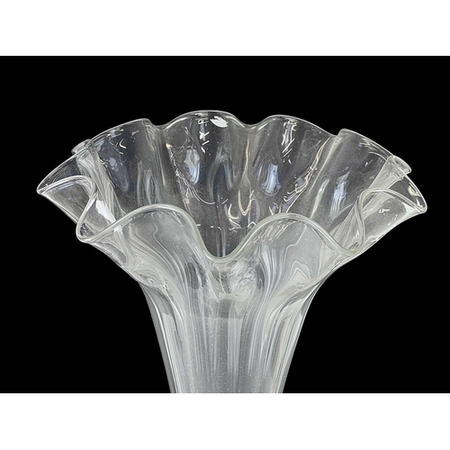 90 - A large glass trumpet vase. Mounted on a stepped oak square base, height 76cm together with a bisque... 