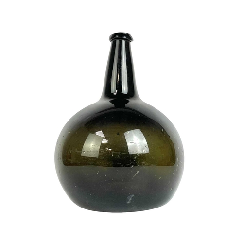 99 - A large free blown green glass onion wine bottle. 18th century, height 32cm.