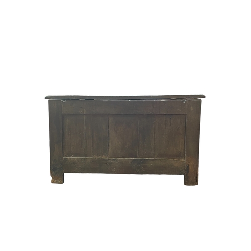 706 - An 18th century oak coffer.
With a two panel front on stile end supports, height 62cm, width 112cm, ... 