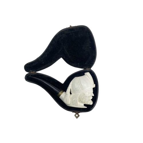 13 - A Meerschaum pipe, carved as a pirate. 20th century, in two sections, length 39cm, cased, together w... 