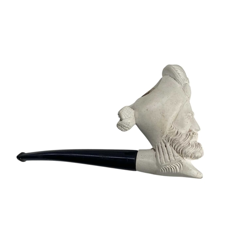 13 - A Meerschaum pipe, carved as a pirate. 20th century, in two sections, length 39cm, cased, together w... 