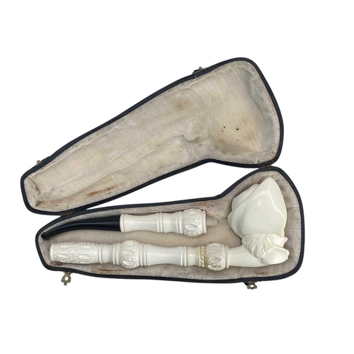 13 - A Meerschaum pipe, carved as a pirate. 20th century, in two sections, length 39cm, cased, together w... 