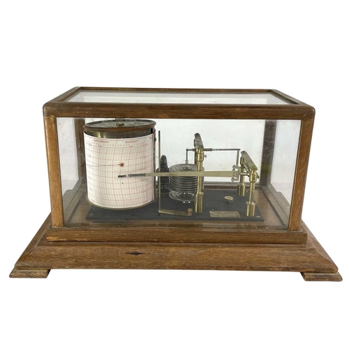 157 - A Negretti & Zambra barograph. Contained in a glazed walnut case, numbered R 40879, length 38cm.