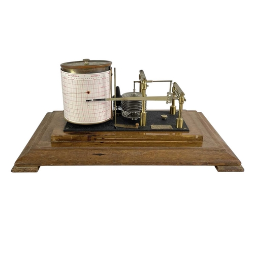 157 - A Negretti & Zambra barograph. Contained in a glazed walnut case, numbered R 40879, length 38cm.