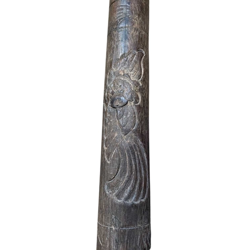 16 - An Australian carved hardwood didgeridoo. Decorated with bird and floral motifs, length 125cm.