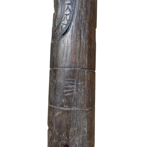 16 - An Australian carved hardwood didgeridoo. Decorated with bird and floral motifs, length 125cm.