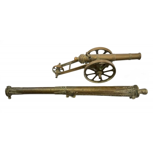 162 - A pair of heavy cast iron models of cannon. Each with a wheeled carriage, length 33cm, together with... 