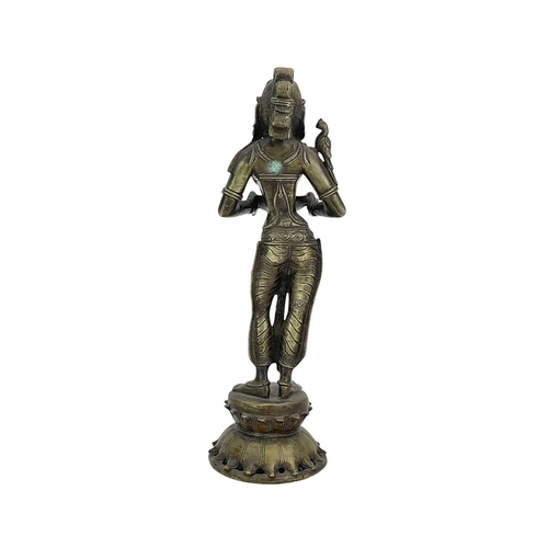 184 - An Indian bronze Lakshmi figure. 20th-century, holding a bowl for incense, standing on a lotus flowe... 