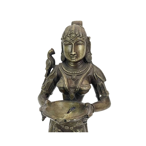 184 - An Indian bronze Lakshmi figure. 20th-century, holding a bowl for incense, standing on a lotus flowe... 