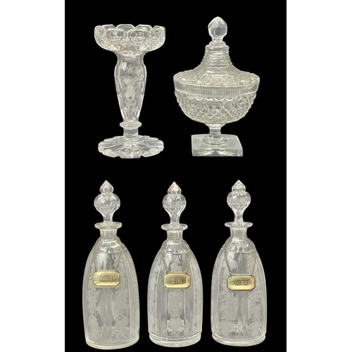 185 - A set of three Victorian engraved glass decanters and stoppers. With plated labels, height 37cm, tog... 