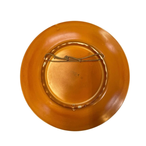 191 - A Royal Doulton circular wall plaque. The orange ground decorated a central roundel, diameter 34cm.